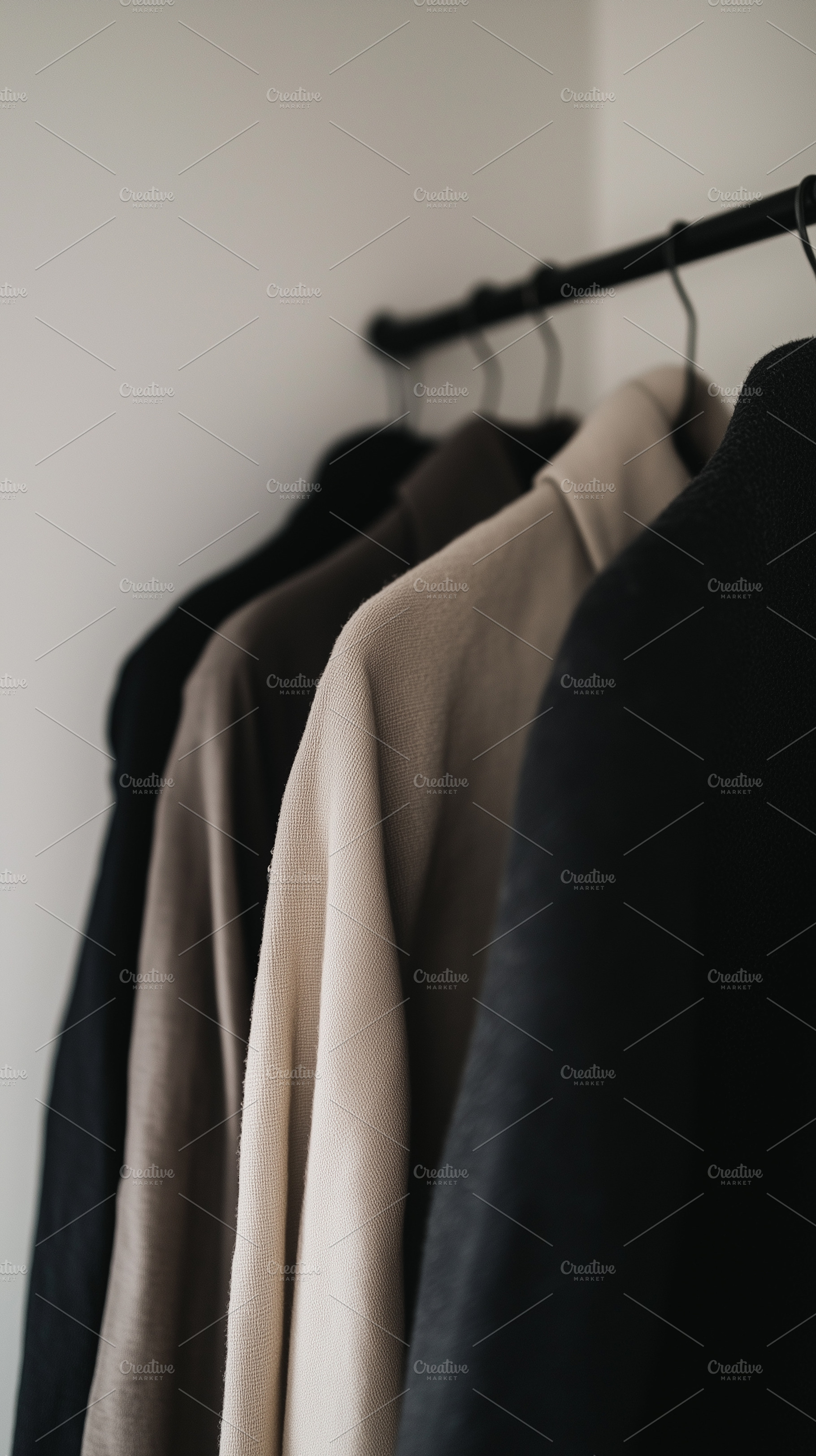 Minimalist neutral shirts hang on a, a Beauty & Fashion Photo by MistyDay