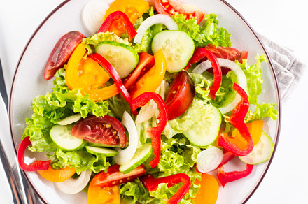 vegetable salad of fresh tomatoes, cucumbers, onions, lettuce on, a Food & Drink Photo by vimart