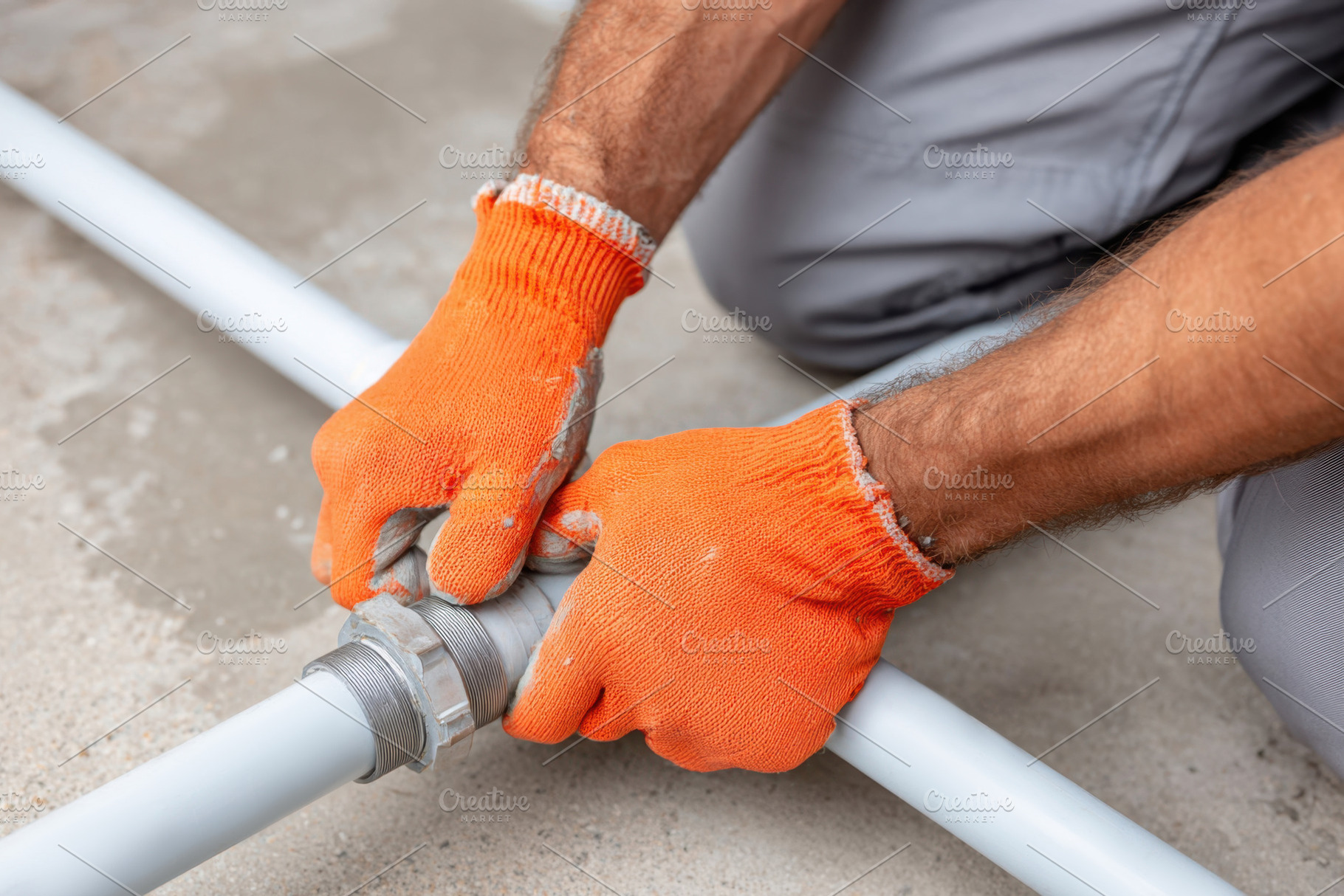 Tightening a pipe fitting in plumbing work, an Industrial Photo by AlyaAnd
