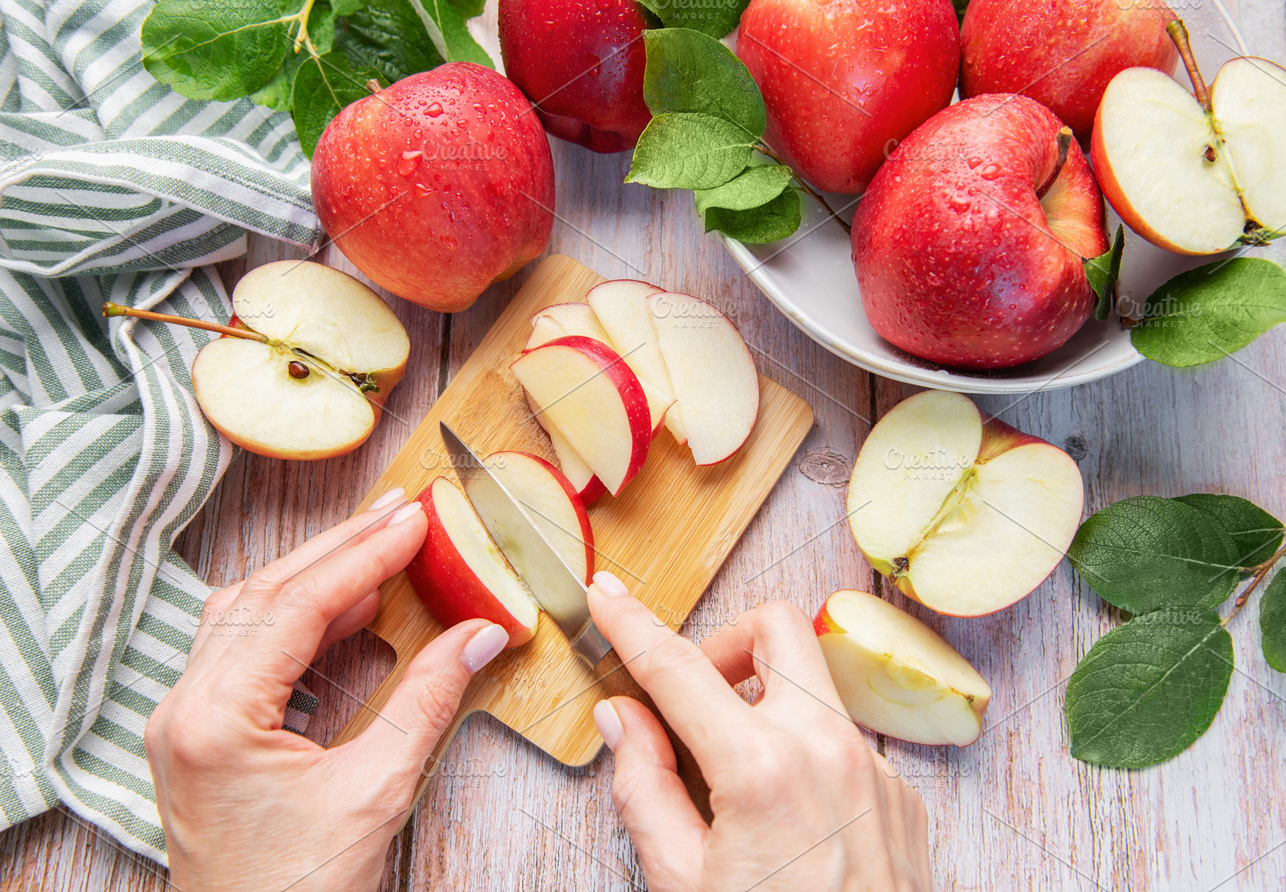 Cutting fresh red apples preparing healthy food, a Food & Drink Photo by Olena Rudo