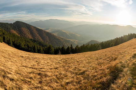 Beautiful sunset and layered mountain silhouettes in evening, a Nature Photo by Byrdyak