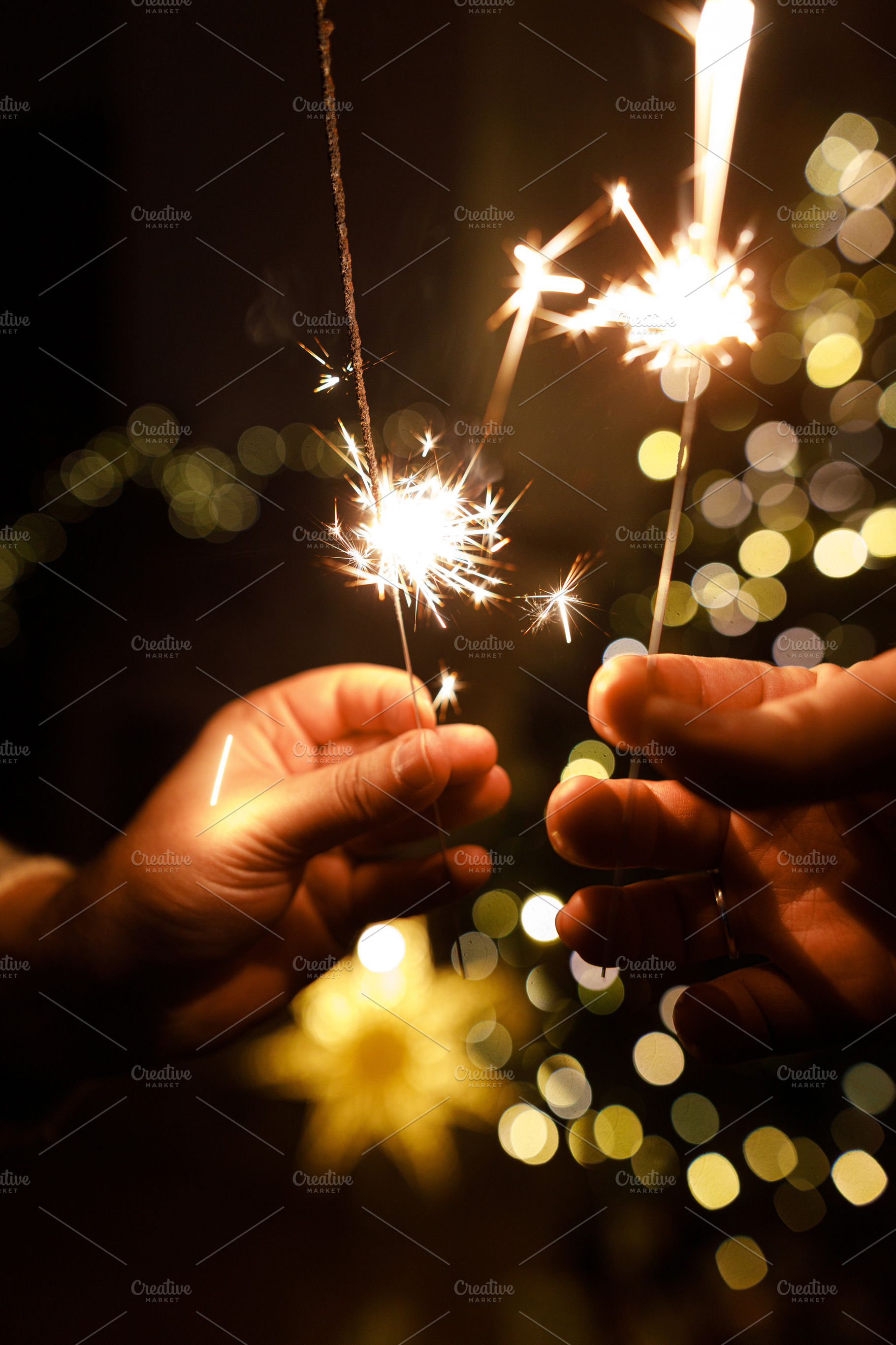 Happy New Year! Burning sparklers in hands on background of chri, a Holiday Photo by Sonjachni