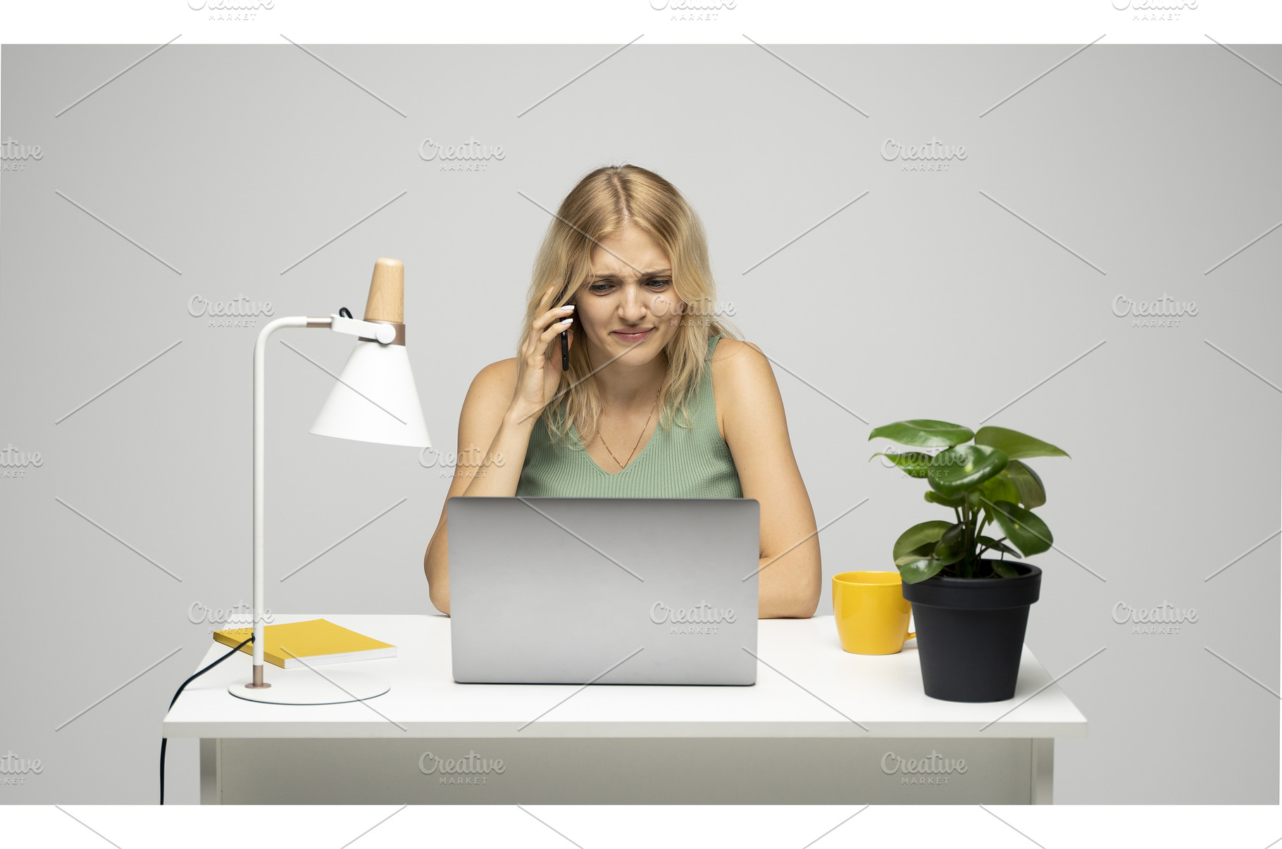 Frustrated young woman in green top, a Technology Photo by volodymyrshtun13795
