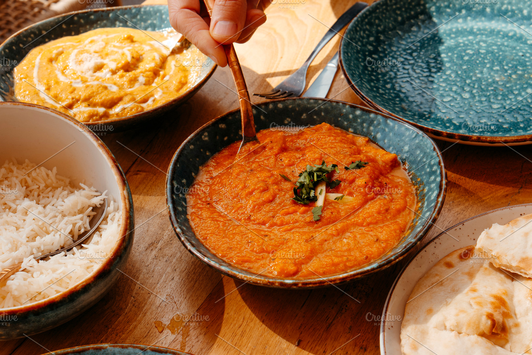 man serving some chicken tikka masala, a Photo by Nito