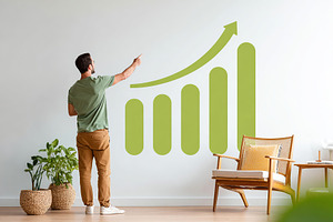 Presenter gestures towards a growing graph in a modern room with plants and min, a Photo by AlyaAnd