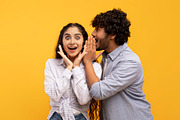 Shock, gossip, share advice. Young indian man whispering to lady on ear, surpri, a Photo by Prostock-Studio (Thumbnail 2 of 4)
