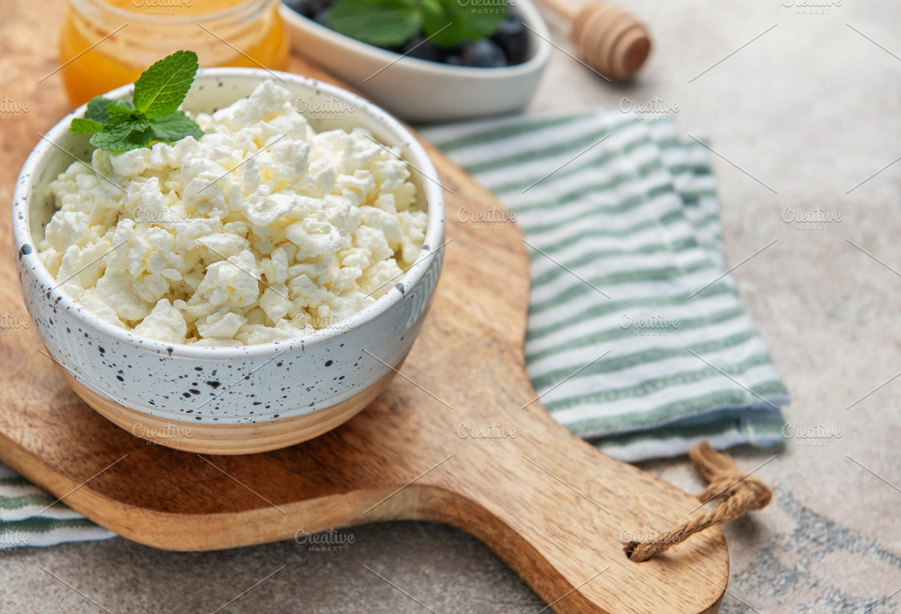 Cottage cheese in bowl with mint and honey, a Food & Drink Photo by Olena Rudo