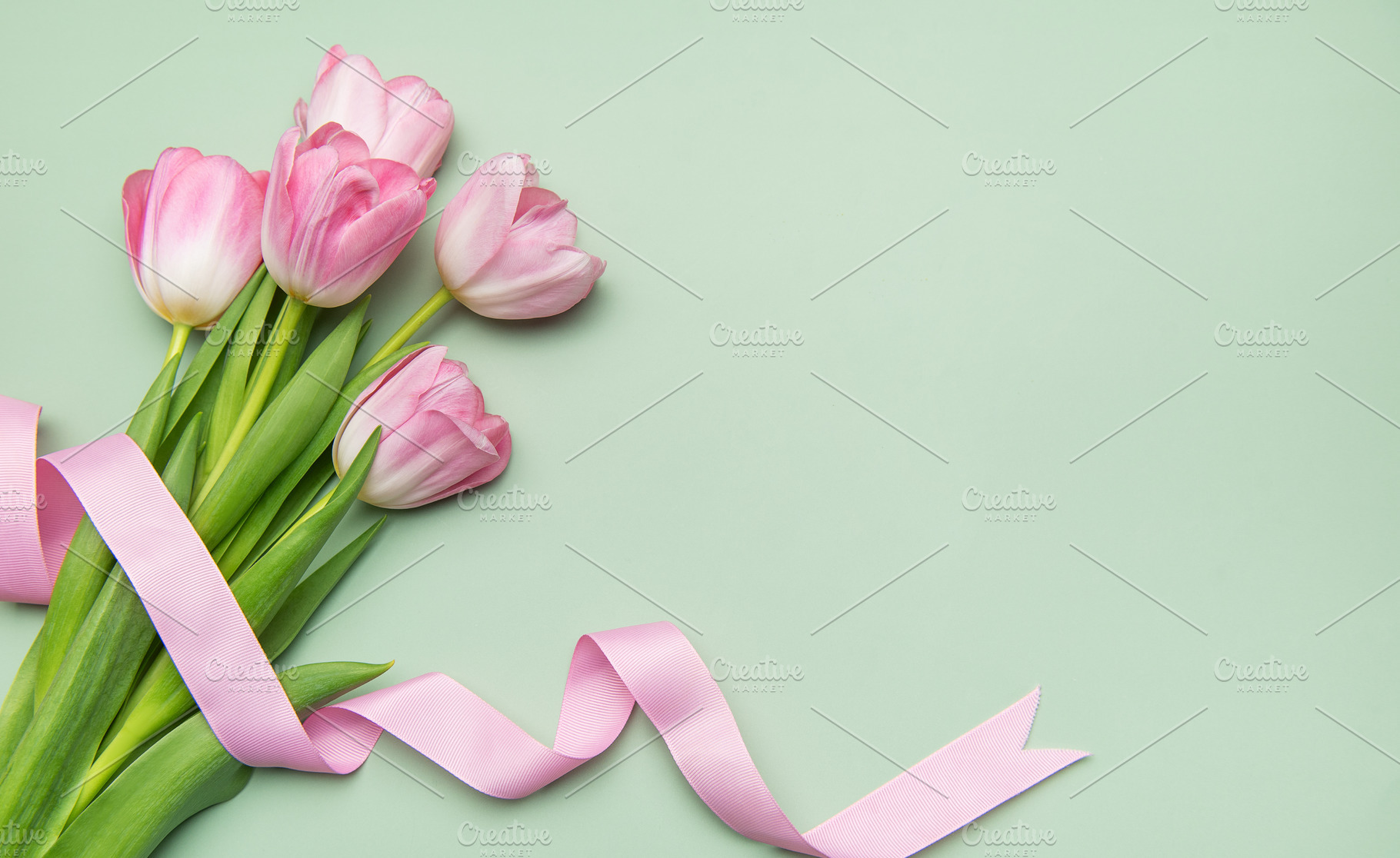 Pink tulips with ribbon on pastel green background for spring ho, a Nature Photo by Olena Rudo
