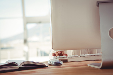 Cropped image of woman typing on keyboard, a Photo by wavebreak