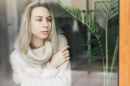 Sad girl near window thinking about something, a Person Photo by Olena Rudo