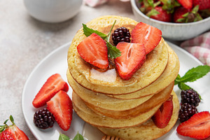 Stack of pancakes with strawberries, blackberries, honey, and mi, a Food & Drink Photo by Olena Rudo