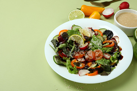 Concept of tasty food with vegetable salad with tahini sauce on, a Background Photo by AtlasStudio PRO