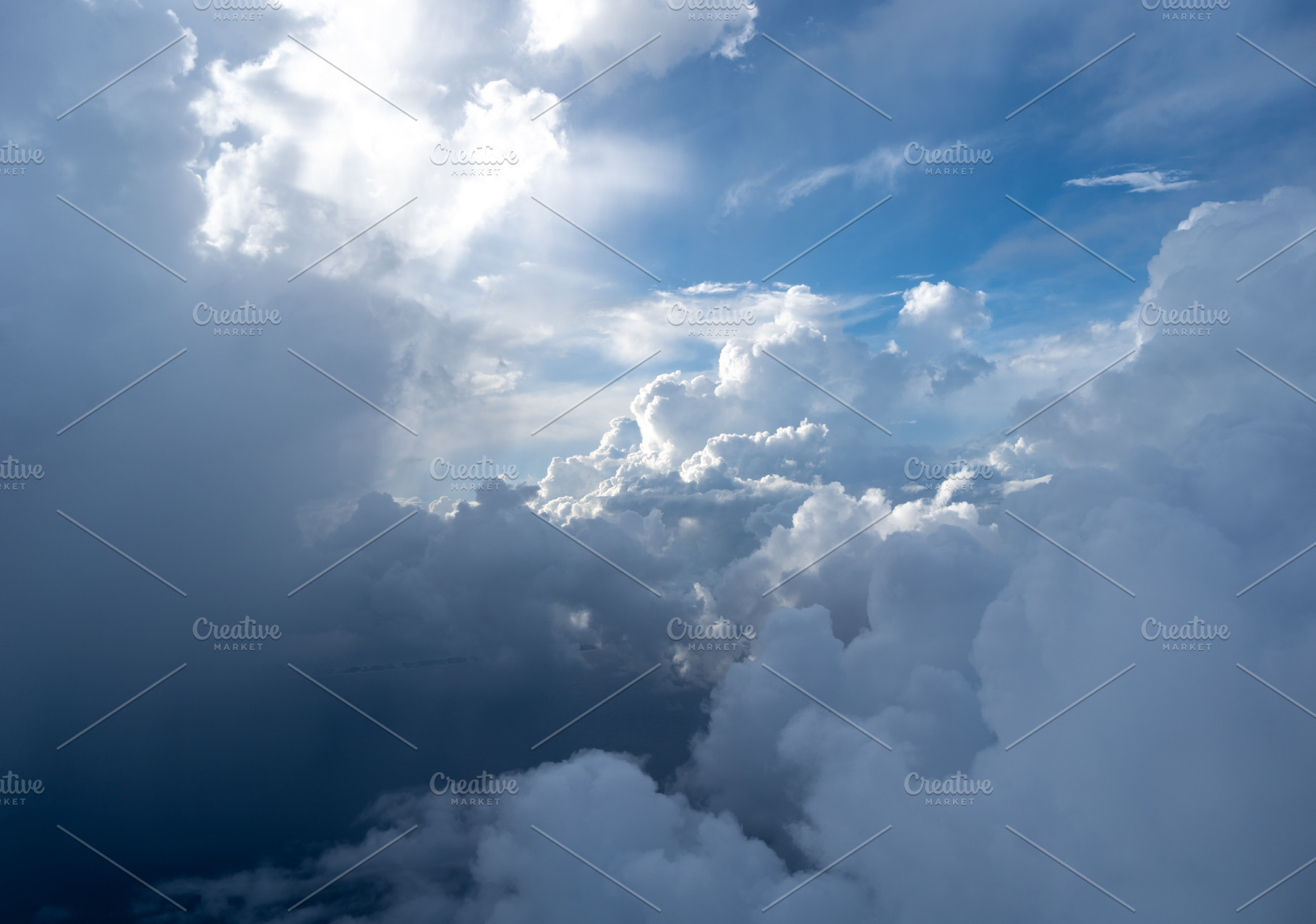Dramatic sky with sunbeams and clouds seen from an airplane, a Nature Photo by GoodGoods