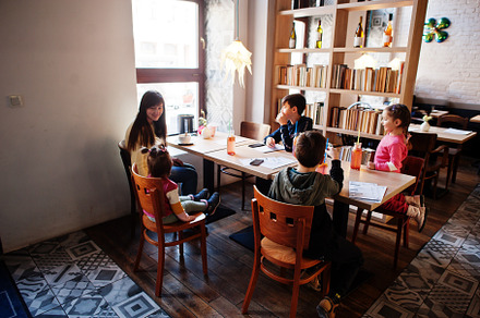 Mother with four kids spending time in cafe. Family lunch in the, a Person Photo by AS photostudio