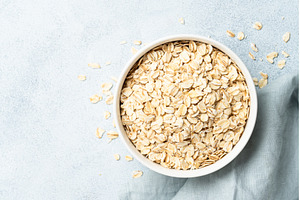 Rolled oats flakes in a wooden bowl, a Food & Drink Photo by Nadia-nb