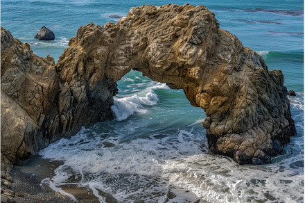 Majestic natural sea arch on rocky, a Nature Photo by Ylivdesign