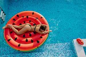 Pool Float woman relax in swimming pool on summer vacations, a Person Photo by Olyryk & Aglo