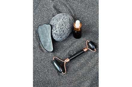 Skincare Tools on Black Sand With, a Beauty & Fashion Photo by tilialucida