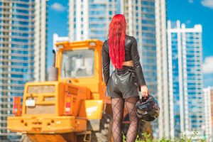 Red haired woman in leather clothes with motorcycle helmet looki, a Photo by Pictures for you!!!!!!!!!
