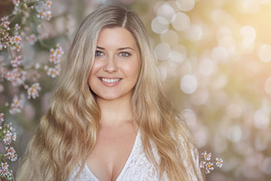 Blonde woman smiling in a natural setting, her long hair flowing, a Person Photo by Studio ANNA