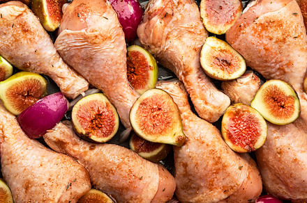 Raw chicken legs, drumsticks with sweet figs and red onions in b, a Food & Drink Photo by 5PH