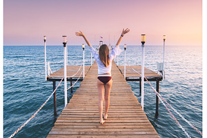 Happy woman in bikini with raised up, a Person Photo by den-belitsky