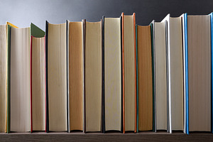 Row of books showing the front edge on a shelf, a School & Education Photo by Davizro's Market