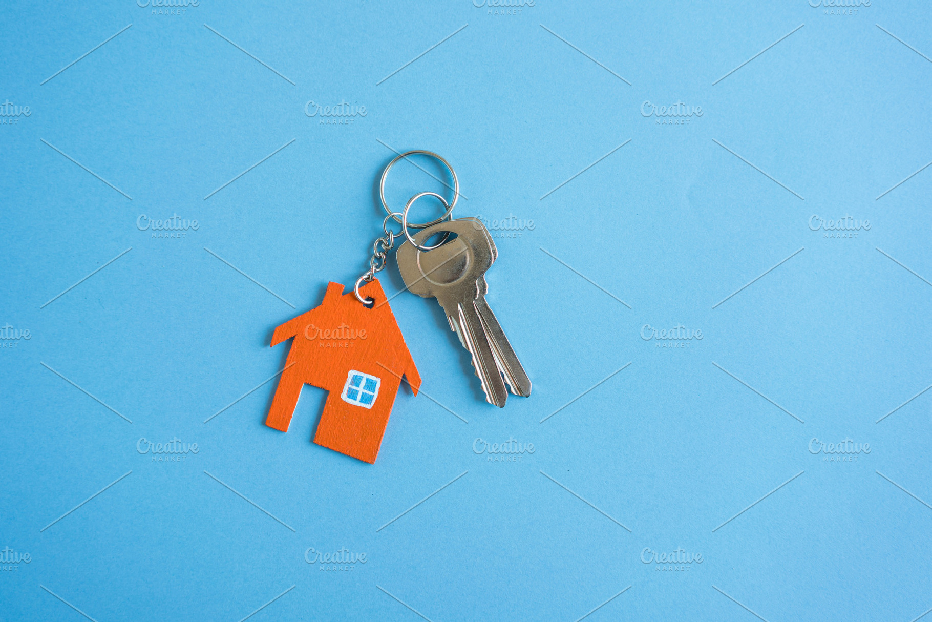 House and key on blue background containing house, key, and apartment, a Business Photo by Nednapa