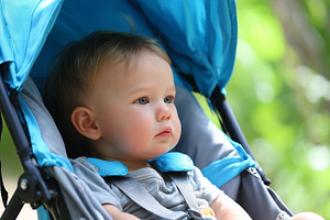 Cute baby sitting in a blue stroller, a Person Photo by MistyDay