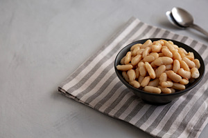Organic Cannellini Beans in a Bowl, side view. Copy space., a Food & Drink Photo by LiudmylaChuhunova