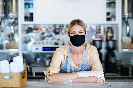 Woman owner with face mask in coffee stock photo containing concept and, a Person Photo by HalfPoint