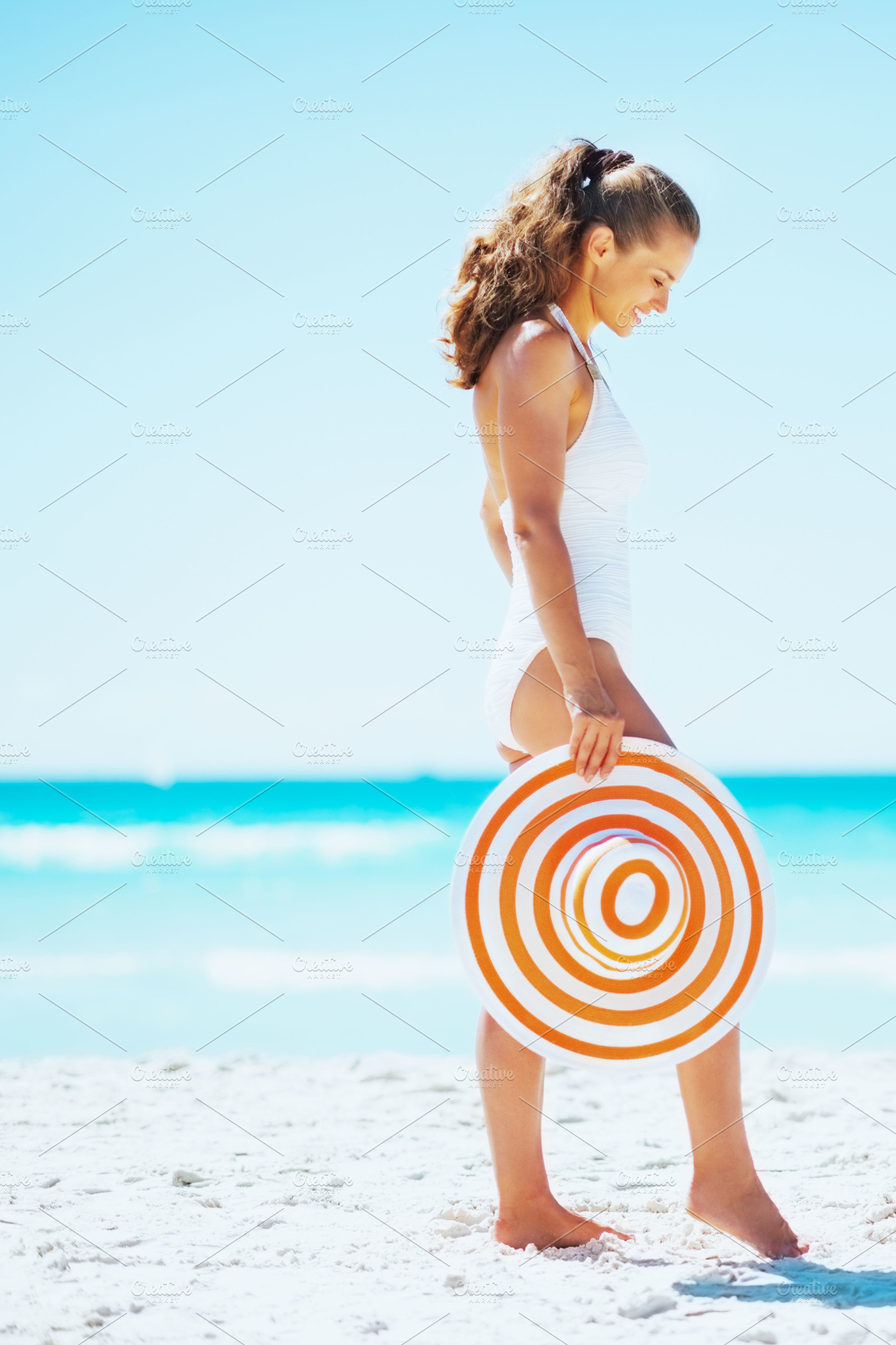 young woman with hat on beach, a Person Photo by Alliance Images