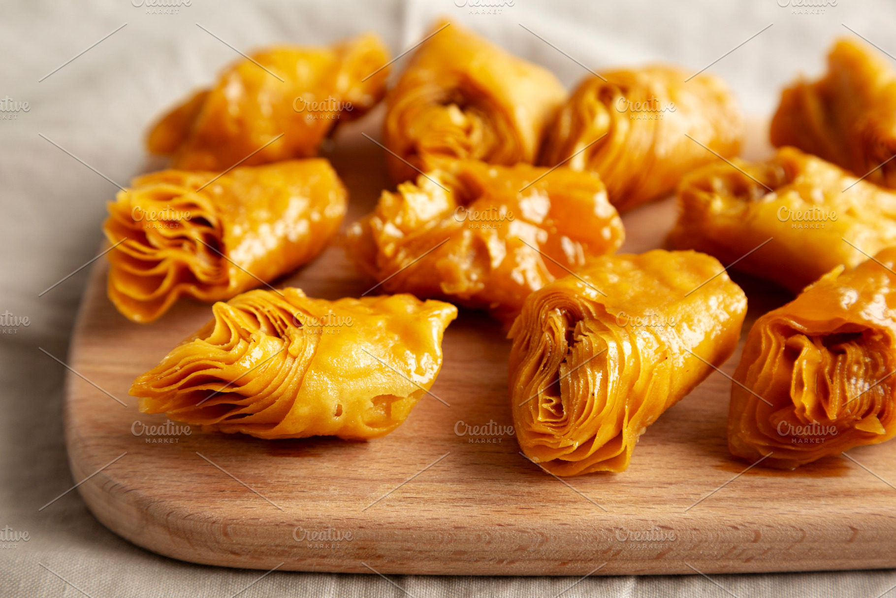 Sweet Homemade Turkish Baklava with Honey on a Wooden Board, sid, a Food & Drink Photo by LiudmylaChuhunova