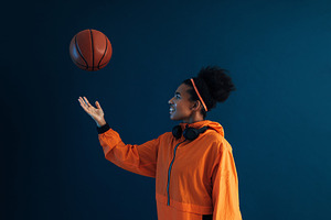 Young basketball woman tosses a ball, a Sports & Recreation Photo by Artem Varnitsin