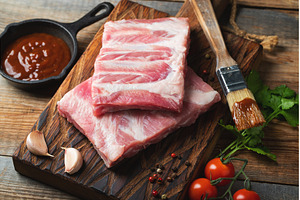 Raw pork ribs with spices, salt and, a Food & Drink Photo by Budarinphoto