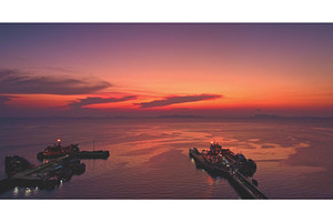Ferry and industrial port at sunset, a Transportation Photo by Goinyk