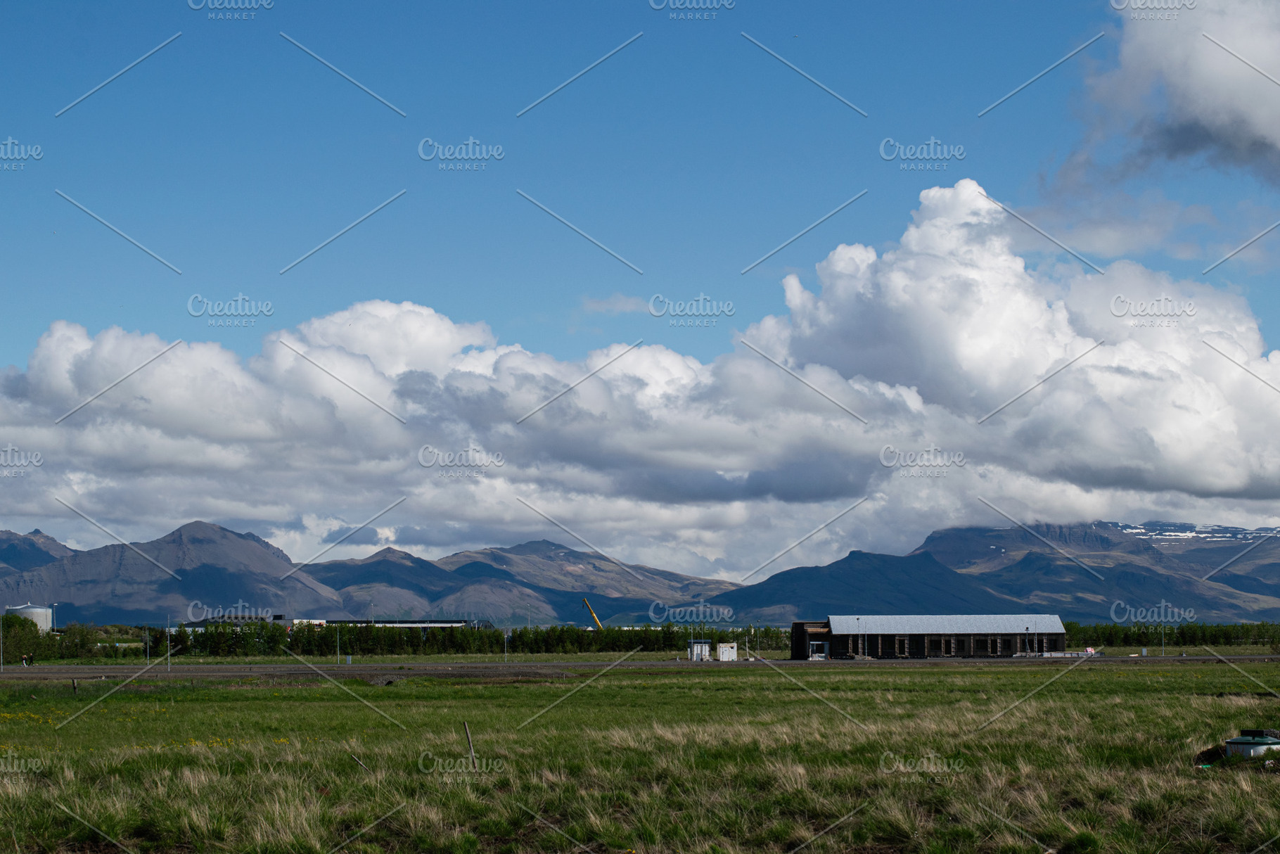 Mountain landscape with clouds and fields in Akranes, Iceland, a Photo by AS photostudio