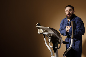 Young man in bathrobe looking surprised while using a stationary, a Person Photo by Ales Munt