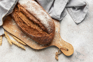 Fresh baked rye bread loaf on wooden board, a Food & Drink Photo by Olena Rudo