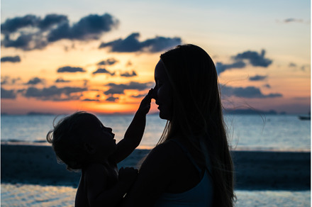 Young woman with child in the sea, a Person Photo by Elizaveta Galitskaya