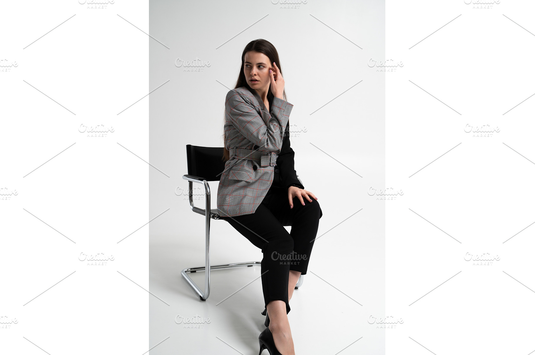 Woman sitting on a modern chair in a, a Business Photo by volodymyrshtun13795