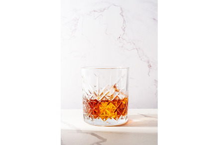 Whiskey with ice cube in the glass