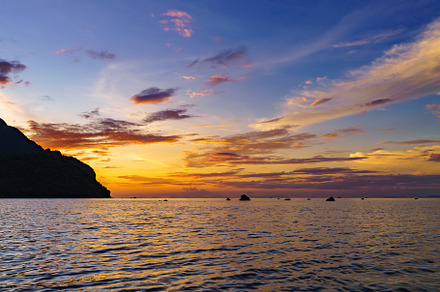 Sea among rocks on evening sunset. Island in tropical waters at, a Nature Photo by Casanowe-studio