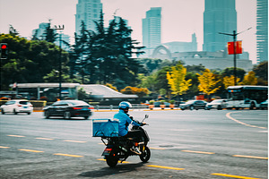 City scene with motorcycles, buses, an Architecture Photo by Our Amazing World