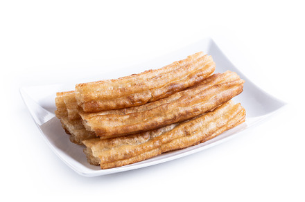 Spanish Churros. Traditional spanish food isolated on white background, a Food & Drink Photo by etorres69