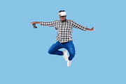Young African American guy in VR headset holding joystick, jumping up in air on, a Photo by Prostock-Studio (Thumbnail 2 of 2)