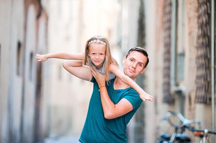 Family in europe happy father and little adorable girl in old city during, a Person Photo by travnikovstudio