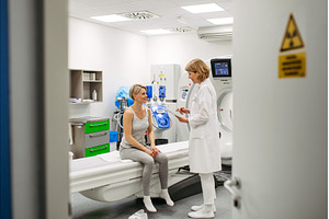 Doctor sharing positive CT scan, a Health & Medical Photo by HalfPoint