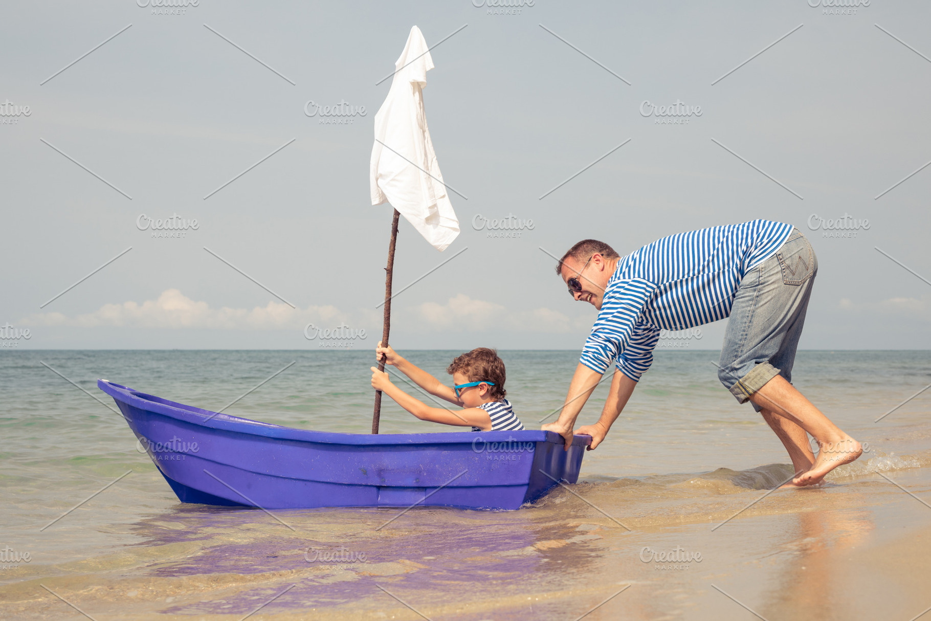 Father and son  playing on the beach containing cruise, fun, and father, a School & Education Photo by altanaka