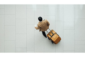 An Asian businessman with a suitcase, a Person Photo by Sergey Kotenev